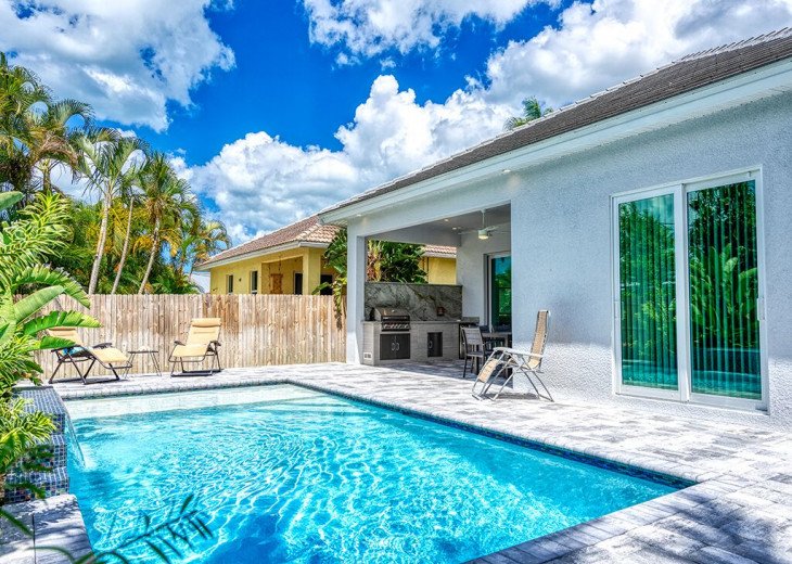 Fenced yard with pool and outdoor kitchen in Florida